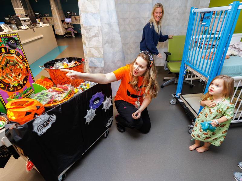 Child life specialist Madeline Wilson helps Children's of Mississippi patient Charlotte Scott Cheatham play a Halloween game.